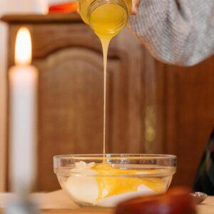 Close-up of honey being poured into a bowl for a delicious recipe.